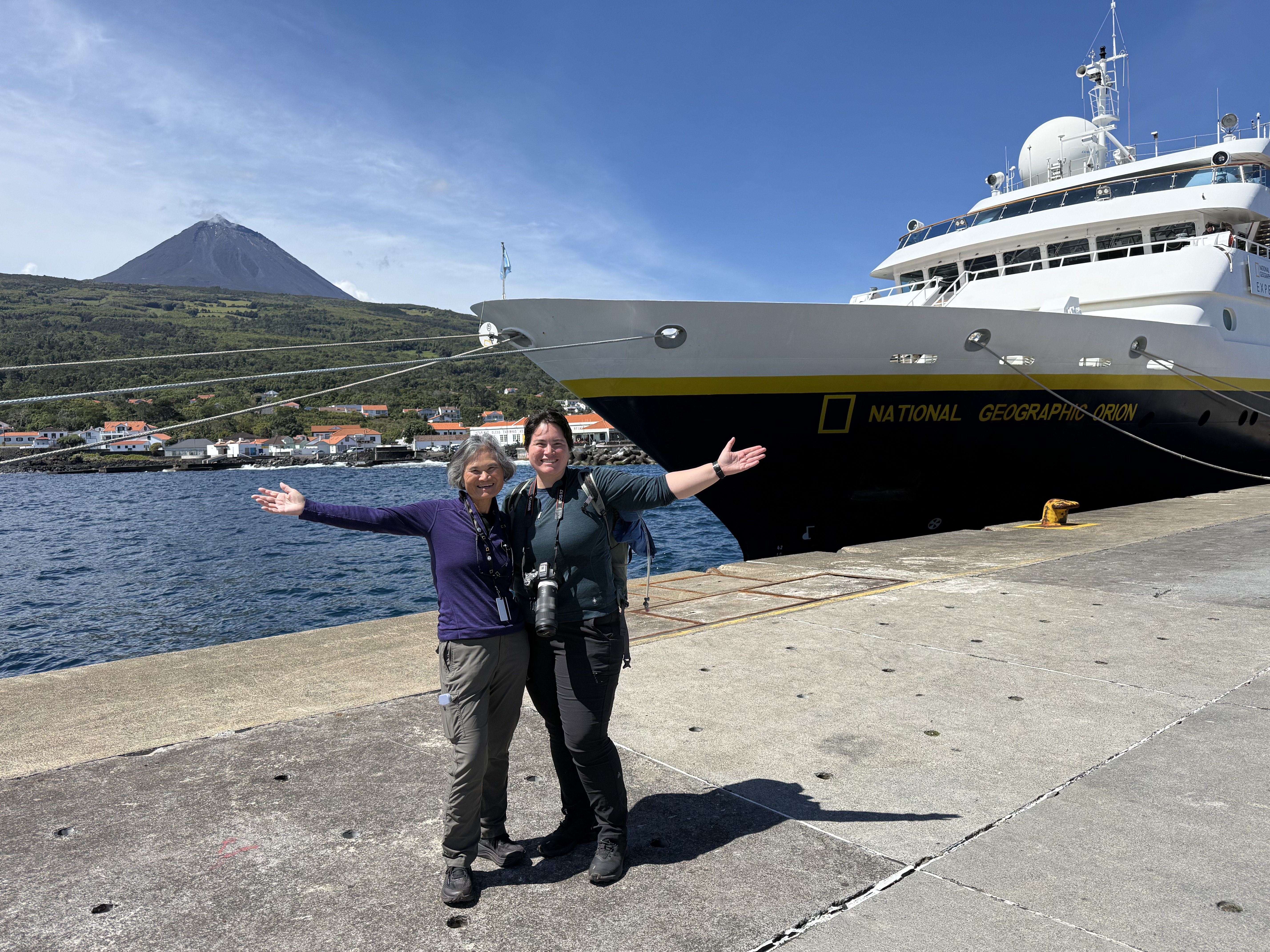 Mei-Mei and Regan (the Globetrotting Kirks) in front of the Orion and Mount Pico, the highest peak in the Azores